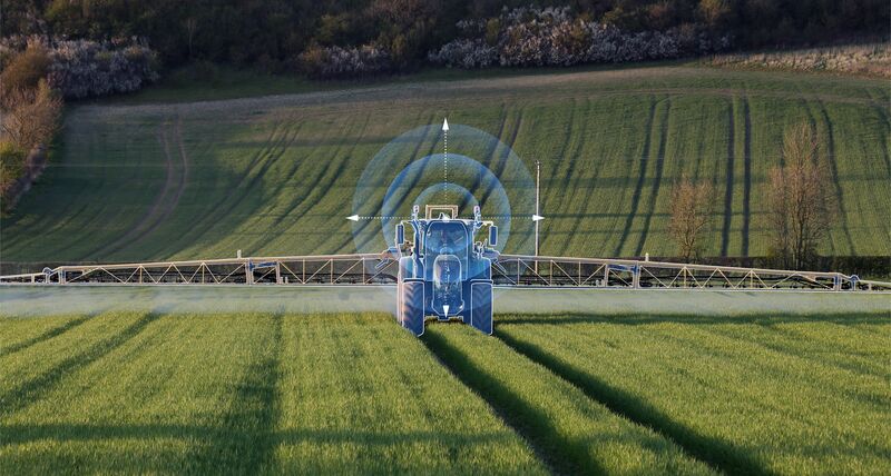 Photograph of tractor with sprayers attached and superimposed crosshairs
